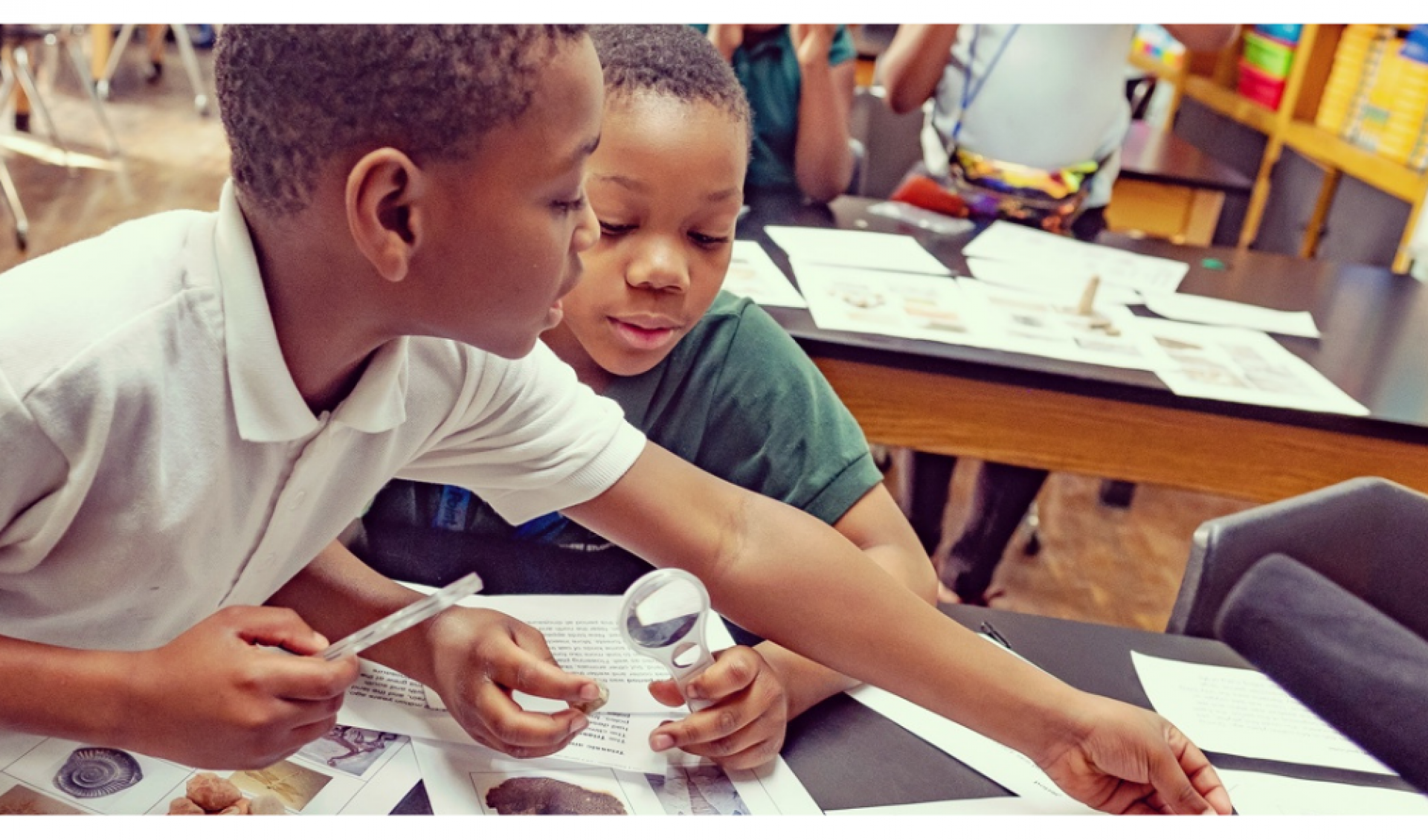 Two boys working on an experiment at desk